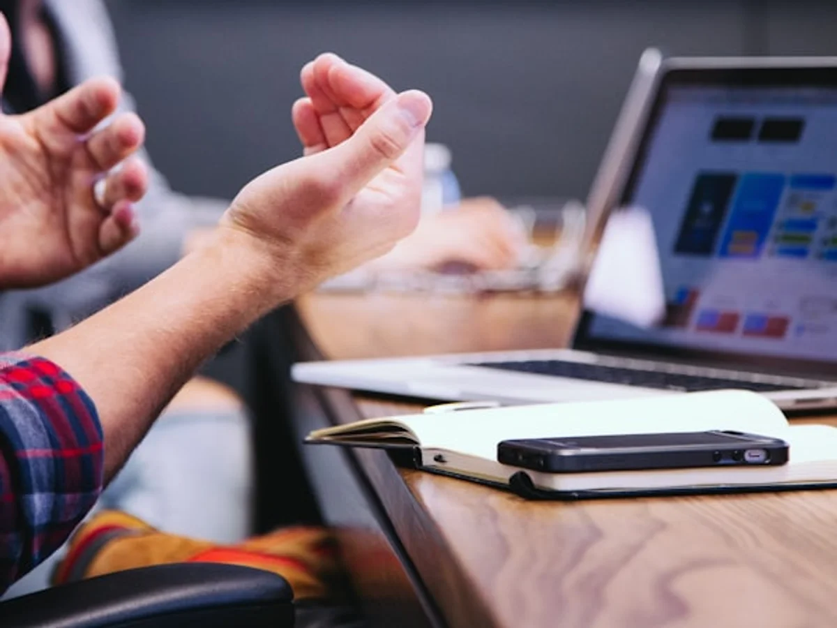 Creator reviewing Instagram profile growth on laptop in a bright workspace