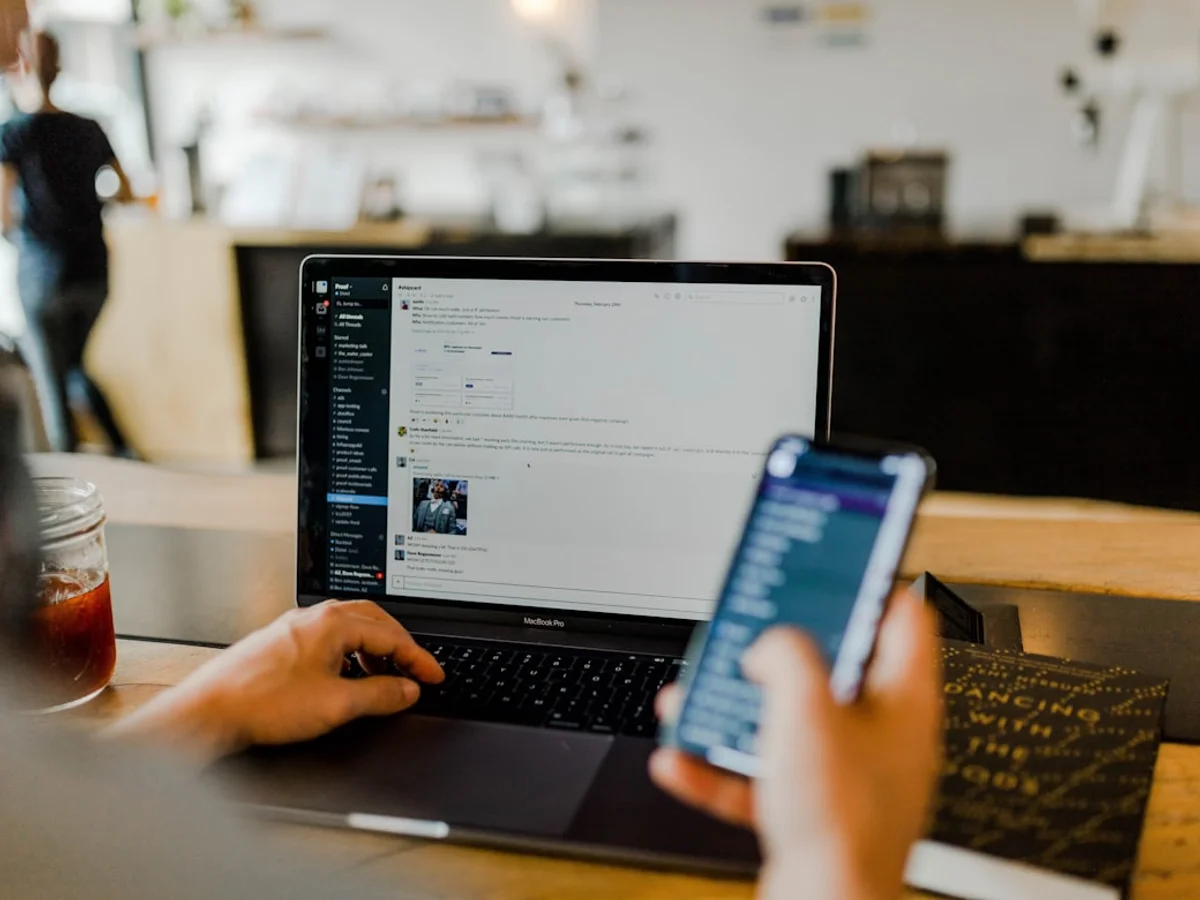 Two people discussing Instagram reach strategy over a laptop screen