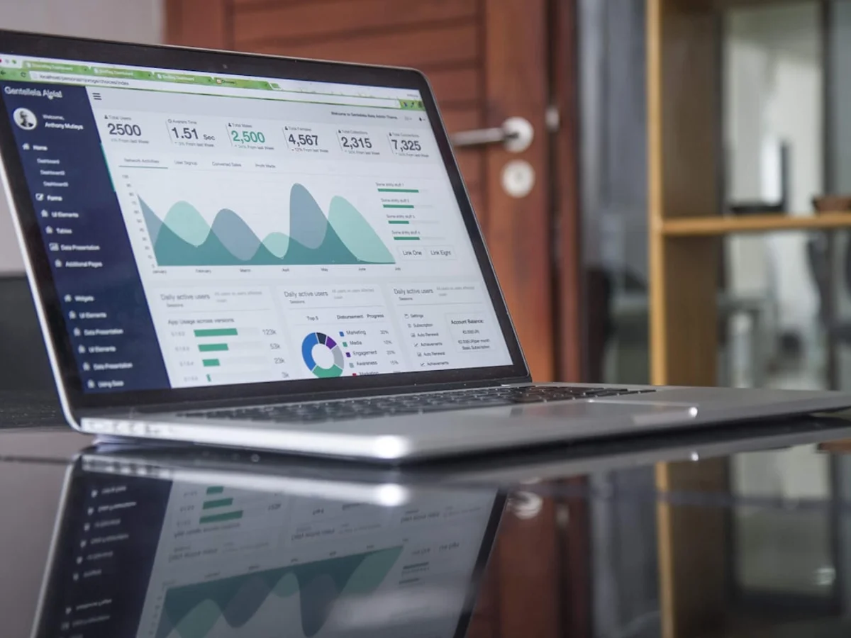 Creator reviewing Instagram reach analytics on a laptop at a desk